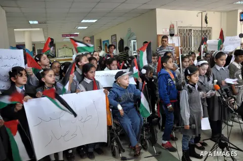 Palestinian students take part a protest against the Israeli blockade on the Gaza Strip, at al-Rantisi hospital, in Gaza city, on Nov. 26, 2013. Gaza has been almost entirely without fuel for weeks, and the resulting shu...