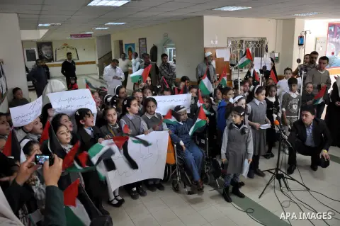 Palestinian students take part a protest against the Israeli blockade on the Gaza Strip, at al-Rantisi hospital, in Gaza city, on Nov. 26, 2013. Gaza has been almost entirely without fuel for weeks, and the resulting shu...