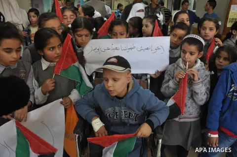Palestinian students take part a protest against the Israeli blockade on the Gaza Strip, at al-Rantisi hospital, in Gaza city, on Nov. 26, 2013. Gaza has been almost entirely without fuel for weeks, and the resulting shu...