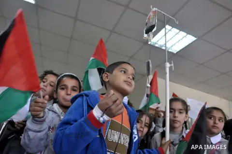 Palestinian students take part a protest against the Israeli blockade on the Gaza Strip, at al-Rantisi hospital, in Gaza city, on Nov. 26, 2013. Gaza has been almost entirely without fuel for weeks, and the resulting shu...