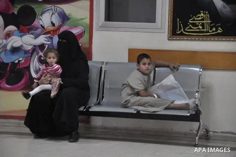 A Palestinian patient waits for treatment at al-Rantisi hospital , in Gaza city, on Nov. 26, 2013. Gaza has been almost entirely without fuel for weeks, and the resulting shut down of the Strip's main power plant and wat...