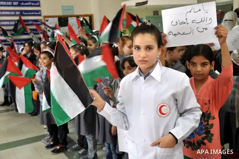 Palestinian students take part a protest against the Israeli blockade on the Gaza Strip, at al-Rantisi hospital, in Gaza city, on Nov. 26, 2013. Gaza has been almost entirely without fuel for weeks, and the resulting shu...