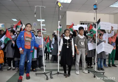 Palestinian students take part a protest against the Israeli blockade on the Gaza Strip, at al-Rantisi hospital, in Gaza city, on Nov. 26, 2013. Gaza has been almost entirely without fuel for weeks, and the resulting shu...