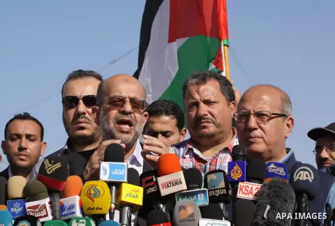 Palestinians and foreigners take part in a protest against the Israeli blockade on Gaza, at Erez crossing between Israel and Gaza Strip November 26, 2013. Israel imposed a blockade on Gaza in 2007 after Islamist group Ha...
