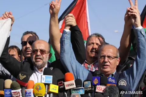 Palestinians and foreigners take part in a protest against the Israeli blockade on Gaza, at Erez crossing between Israel and Gaza Strip November 26, 2013. Israel imposed a blockade on Gaza in 2007 after Islamist group Ha...