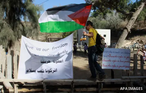 Palestinian children take part in a protest against the Israeli threats of demolition the park of Masoudieh in the West Bank village of Burqa, west of Nablus, November 26, 2013. Photo by Nedal Eshtayah