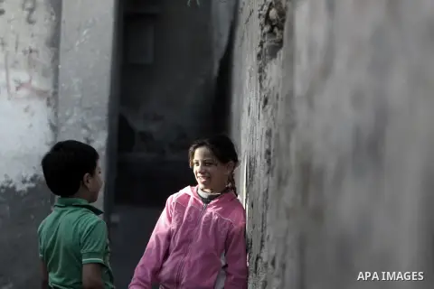 Palestinian children play in the street, in Rafah refugee camp in southern Gaza Strip, November 26, 2013. United Nations officials voiced their solidarity with the people of Palestine in their aspirations for independenc...