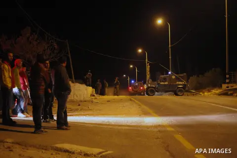 Israeli soldiers stand at the scene of a shooting in which three Palestinians were shot dead by the Israeli army in the village of Yatta, south of the West Bank city of Hebron, on November 26, 2013. Israeli forces shot a...
