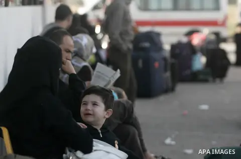 Palestinians hoping to cross into Egypt, sits next to suitcases as their wait at the Rafah crossing between Egypt and the southern Gaza Strip November 27, 2013. Egyptian authorities partially opened the Rafah crossing, G...