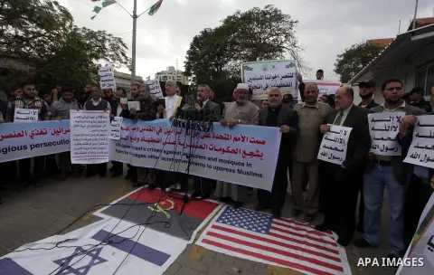 Palestinian protesters hold placards during a protest against Angola's government, in Gaza City on November 27, 2013. Angola's government on November 26, 2013 denied it had banned Islam and closed mosques in the country,...