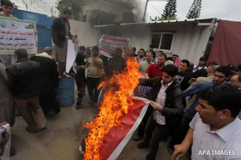 Palestinian protester burn an Angola flag during a protest against Angola's government, in Gaza City on November 27, 2013. Angola's government on November 26, 2013 denied it had banned Islam and closed mosques in the cou...