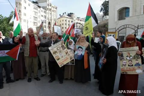 Palestinian relatives of a prisoners hold posters and placards during a demonstration calling for the release of Palestinian prisoners in Israeli jails, in the West Bank City of Nablus, November 27, 2013. Photo by Nedal...