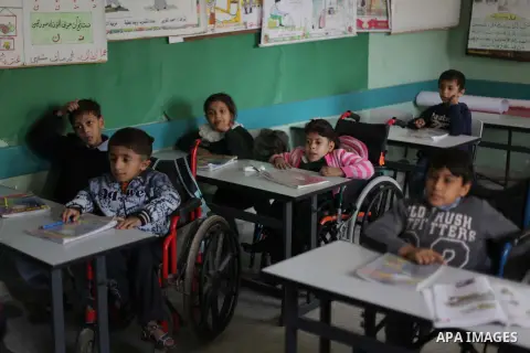 Palestinian disabled children take part in a class at a school of rehabilitation in Gaza City on November 27, 2013. The school founded since 1993 aims to provide educational services, therapeutic, psychological and leisu...