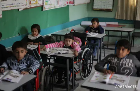 Palestinian disabled children take part in a class at a school of rehabilitation in Gaza City on November 27, 2013. The school founded since 1993 aims to provide educational services, therapeutic, psychological and leisu...