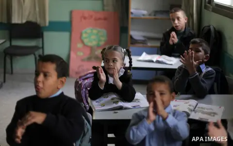Palestinian disabled children take part in a class at a school of rehabilitation in Gaza City on November 27, 2013. The school founded since 1993 aims to provide educational services, therapeutic, psychological and leisu...