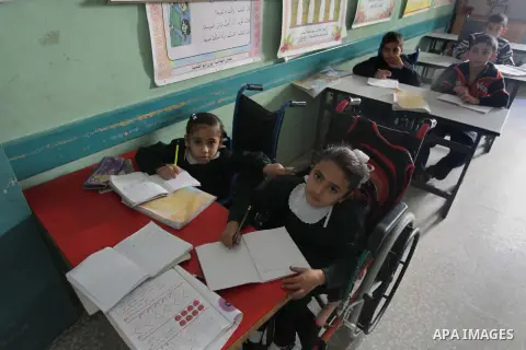 Palestinian disabled children take part in a class at a school of rehabilitation in Gaza City on November 27, 2013. The school founded since 1993 aims to provide educational services, therapeutic, psychological and leisu...