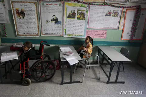 Palestinian disabled children take part in a class at a school of rehabilitation in Gaza City on November 27, 2013. The school founded since 1993 aims to provide educational services, therapeutic, psychological and leisu...