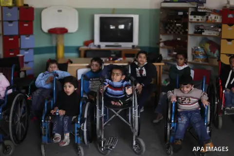 Palestinian disabled children take part in a class at a school of rehabilitation in Gaza City on November 27, 2013. The school founded since 1993 aims to provide educational services, therapeutic, psychological and leisu...