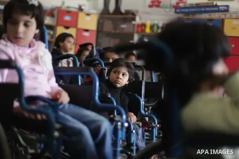 Palestinian disabled children take part in a class at a school of rehabilitation in Gaza City on November 27, 2013. The school founded since 1993 aims to provide educational services, therapeutic, psychological and leisu...