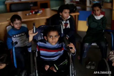 Palestinian disabled children take part in a class at a school of rehabilitation in Gaza City on November 27, 2013. The school founded since 1993 aims to provide educational services, therapeutic, psychological and leisu...