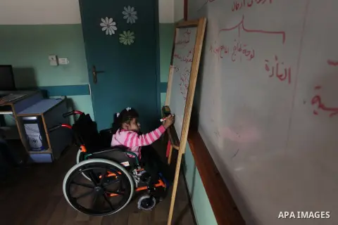 Palestinian disabled children take part in a class at a school of rehabilitation in Gaza City on November 27, 2013. The school founded since 1993 aims to provide educational services, therapeutic, psychological and leisu...