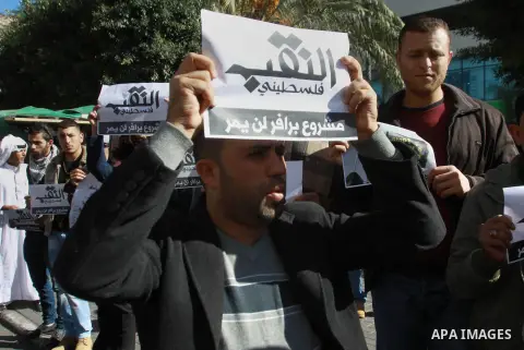 Palestinian protesters shout slogans during a demonstration to show solidarity with Bedouin citizens, in the West Bank city of Nablus, on Nov. 30, 2013. Thousands of Bedouin marched demonstrated to protest a government p...