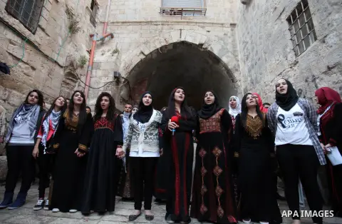Palestinian girls take part in an activities to encourage people of the area to stay in their homes Al-Qurma neighborhood of the Old City, on Nov. 30, 2013. Landslides began seven years ago due to the network of tunnels...