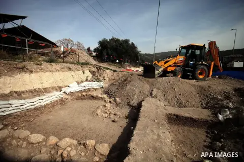 An Israeli Israel Antiquities Authority employee inspects a site of excavation revealed at the main access road to Israeli settlement of Beit Shemesh, near Jerusalem on Dec. 01, 2013. An archaeological excavation near Je...