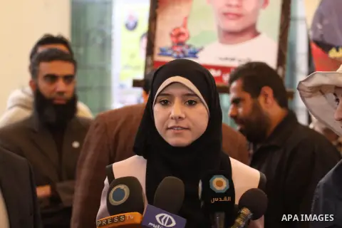 Isra Al-Modallal, a spokeswoman of the Palestinian government in Gaza, talks to the media during a protest in a protest demanding the release of Palestinian prisoners held in Israeli jails, in front of the Red Cross offi...