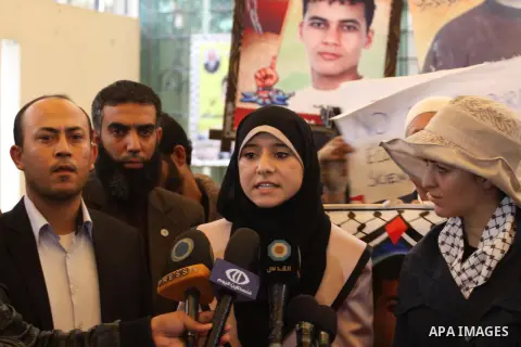 Isra Al-Modallal, a spokeswoman of the Palestinian government in Gaza, talks to the media during a protest in a protest demanding the release of Palestinian prisoners held in Israeli jails, in front of the Red Cross offi...