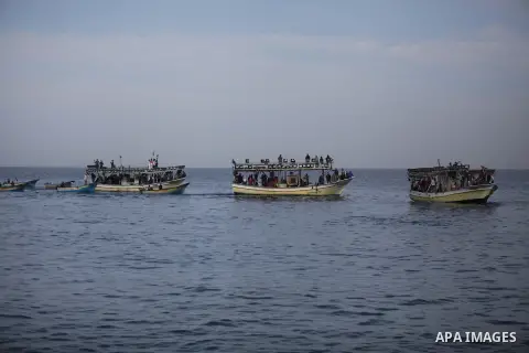 Palestinians sail their boats as part of a convoy that was launched at the initiative of the "Intifada Youth Coalition" (IYC) to break the naval blockade of Gaza as a protest against the Israeli siege on December 2, 2013...