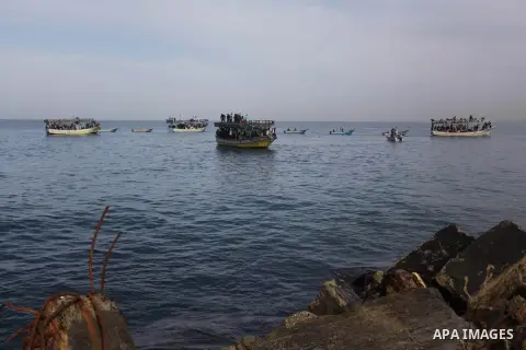 Palestinians sail their boats as part of a convoy that was launched at the initiative of the "Intifada Youth Coalition" (IYC) to break the naval blockade of Gaza as a protest against the Israeli siege on December 2, 2013...