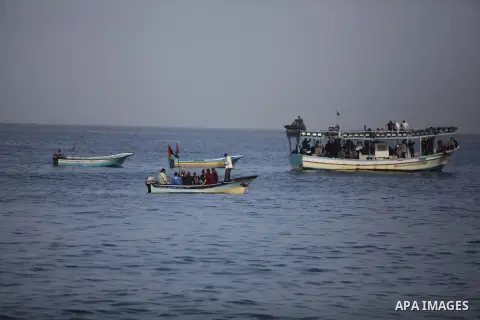 Palestinians sail their boats as part of a convoy that was launched at the initiative of the "Intifada Youth Coalition" (IYC) to break the naval blockade of Gaza as a protest against the Israeli siege on December 2, 2013...