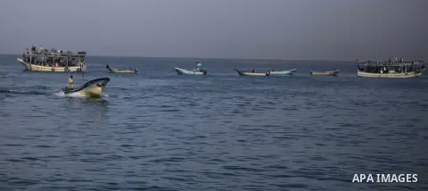 Palestinians sail their boats as part of a convoy that was launched at the initiative of the "Intifada Youth Coalition" (IYC) to break the naval blockade of Gaza as a protest against the Israeli siege on December 2, 2013...