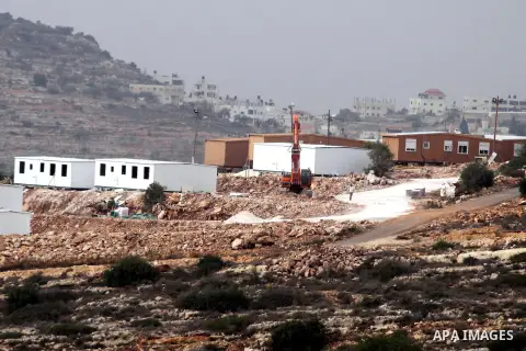 Bungalows built by Israeli settlers at an outpost constructed on seized land from the Palestinian village of al-Mazraa al-Kubliyeh, near the West Bank city of Birzeit, are seen on the hillside on December 3, 2013. Palest...