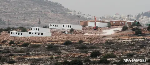 Bungalows built by Israeli settlers at an outpost constructed on seized land from the Palestinian village of al-Mazraa al-Kubliyeh, near the West Bank city of Birzeit, are seen on the hillside on December 3, 2013. Palest...