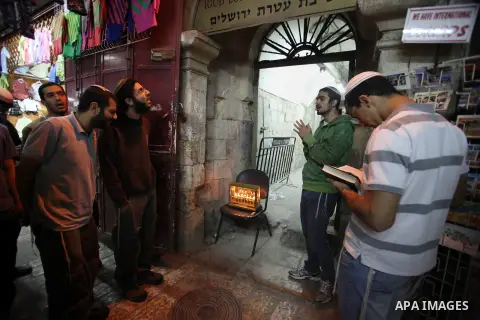 Ultra-Orthodox Jews light the fifth Hanukkah candle during the Jewish holiday of Hanukkah in Jerusalem's Mea Shearim neighbourhood, on Dec. 3, 2013. Hanukkah, also known as the Festival of Lights, is one of the most impo...
