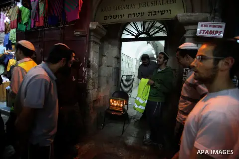 Ultra-Orthodox Jews light the fifth Hanukkah candle during the Jewish holiday of Hanukkah in Jerusalem's Mea Shearim neighbourhood, on Dec. 3, 2013. Hanukkah, also known as the Festival of Lights, is one of the most impo...