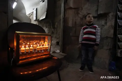 Ultra-Orthodox Jews light the fifth Hanukkah candle during the Jewish holiday of Hanukkah in Jerusalem's Mea Shearim neighbourhood, on Dec. 3, 2013. Hanukkah, also known as the Festival of Lights, is one of the most impo...