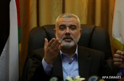 Palestinian Prime Minister in Gaza, Ismail Haniyeh, speaks at a meeting during his visit to the Court of eliminating the legitimate, in Gaza City on Dec. 04, 2013. Photo by Ashraf Amra