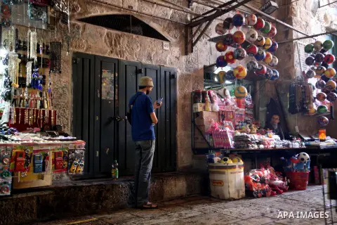 An Ultra-Orthodox Jewish stands in front of closed shop during a protest against the storming of Al-Aqsa Mosque, in Jerusalem's Old City December 4, 2013. Hanukkah, also known as the Festival of Lights, is one of the mos...