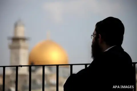 An Ultra-Orthodox Jewish looks on the Dome of The Rock mosque is seen December 4, 2013. Hanukkah, also known as the Festival of Lights, is one of the most important Jewish holidays and celebrated by Jews worldwide during...