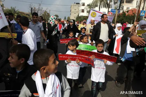 Palestinians and physically challenged people take part in a rally marking the International Day of Persons with Disabilities in Gaza City on Dec. 04, 2013. According to a United Nations report on disabilities, physical,...