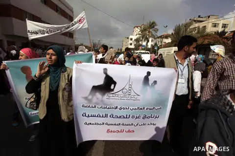 Palestinians and physically challenged people take part in a rally marking the International Day of Persons with Disabilities in Gaza City on Dec. 04, 2013. According to a United Nations report on disabilities, physical,...