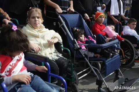 Palestinians and physically challenged people take part in a rally marking the International Day of Persons with Disabilities in Gaza City on Dec. 04, 2013. According to a United Nations report on disabilities, physical,...