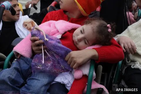 Palestinians and physically challenged people take part in a rally marking the International Day of Persons with Disabilities in Gaza City on Dec. 04, 2013. According to a United Nations report on disabilities, physical,...