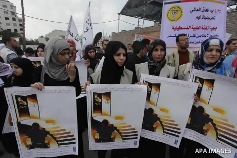 Palestinians and physically challenged people take part in a rally marking the International Day of Persons with Disabilities in Gaza City on Dec. 04, 2013. According to a United Nations report on disabilities, physical,...