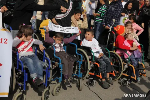 Palestinians and physically challenged people take part in a rally marking the International Day of Persons with Disabilities in Gaza City on Dec. 04, 2013. According to a United Nations report on disabilities, physical,...