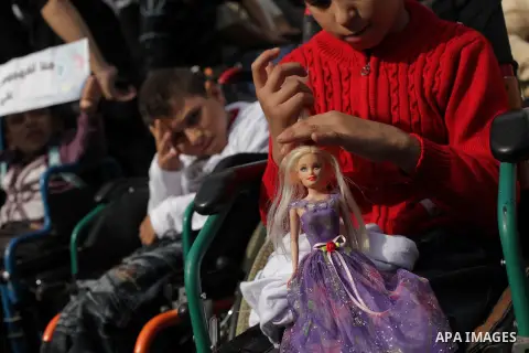 Palestinians and physically challenged people take part in a rally marking the International Day of Persons with Disabilities in Gaza City on Dec. 04, 2013. According to a United Nations report on disabilities, physical,...