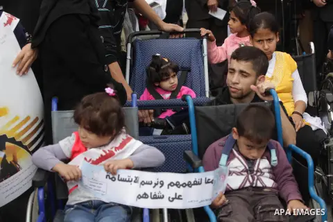 Palestinians and physically challenged people take part in a rally marking the International Day of Persons with Disabilities in Gaza City on Dec. 04, 2013. According to a United Nations report on disabilities, physical,...